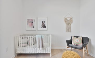 a bedroom with a bed and a chair in a room