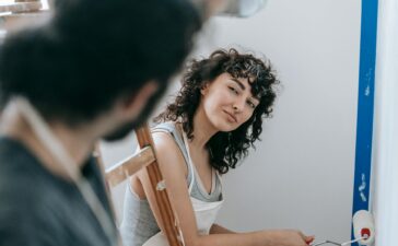 A couple enjoying painting their new home together, creating a vibrant and cozy space.